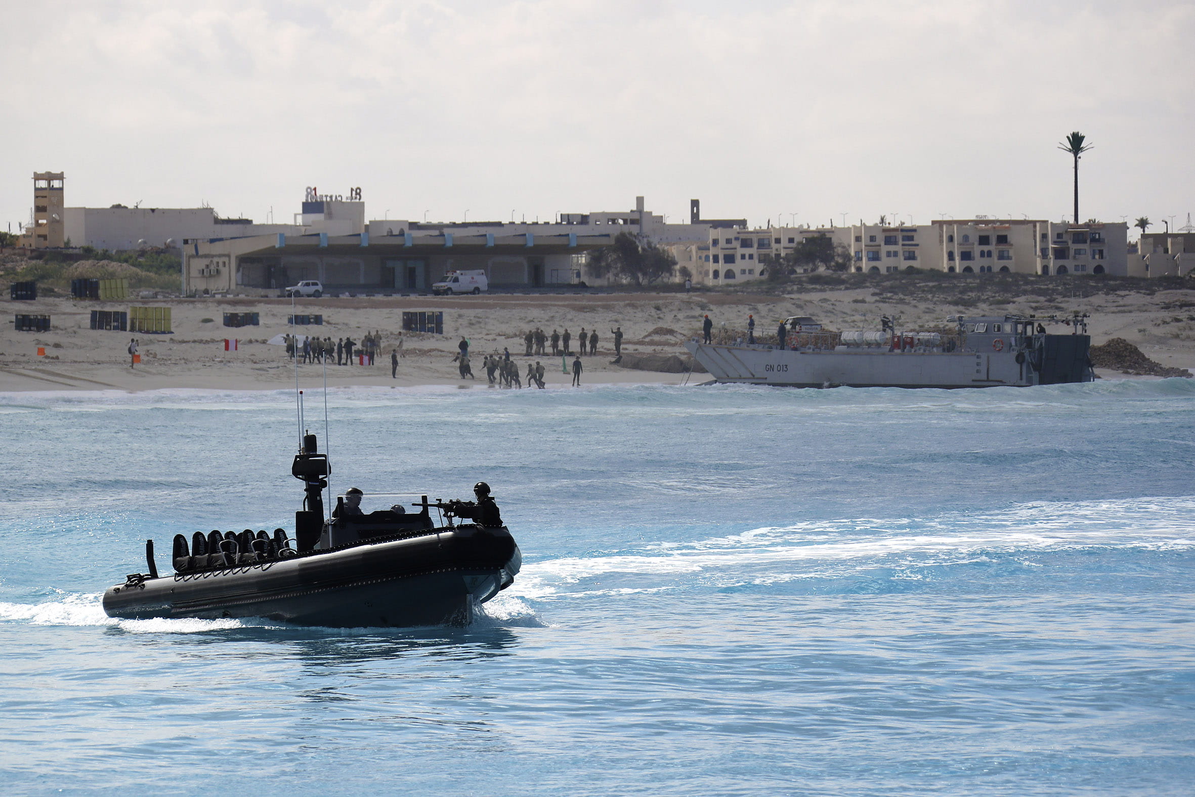 Egyptian troops come ashore by landing craft as a Royal Marines ORC patrols offshore