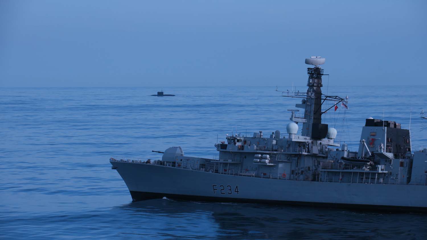 HMS Iron Duke tracks a surfaced Russian submarine