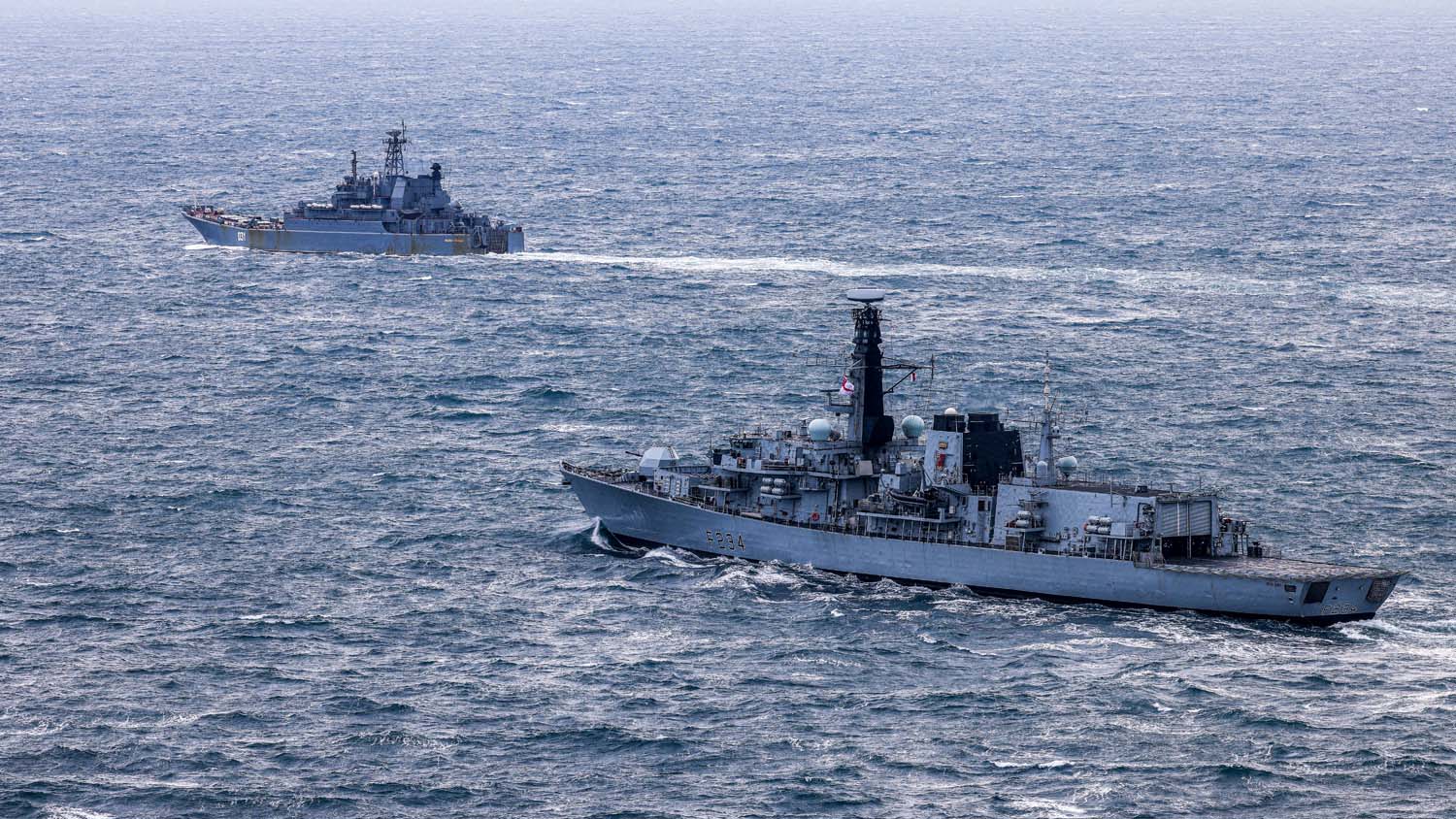 HMS Iron Duke tracks the progress of a Russian landing ship