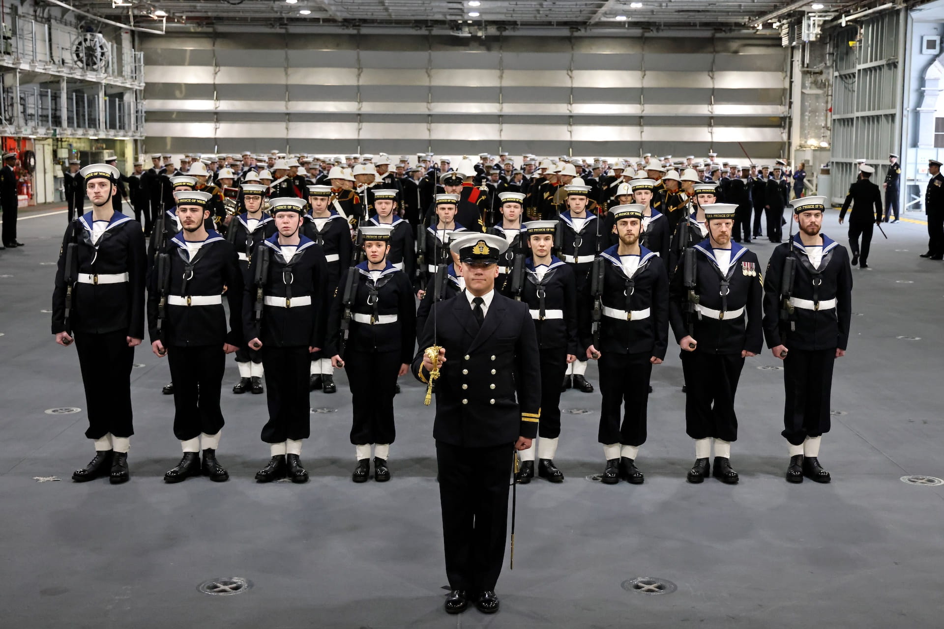 The aft hangar filled with ships company and RM Band on parade for the ceremony