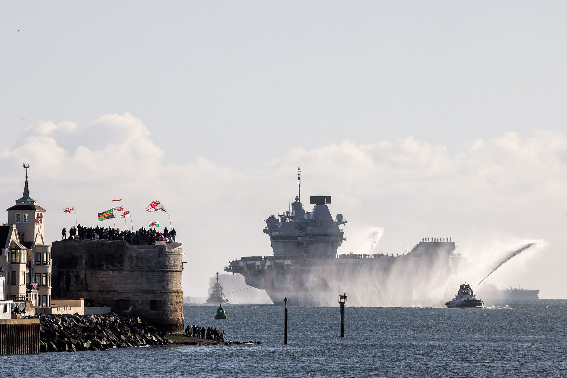 Tugs spray jets of water in tribute as HMS Prince of Wales approaches the crowds on Round Tower Tugs spray jets of water in tribute as HMS Prince of Wales approaches the crowds on Round Tower