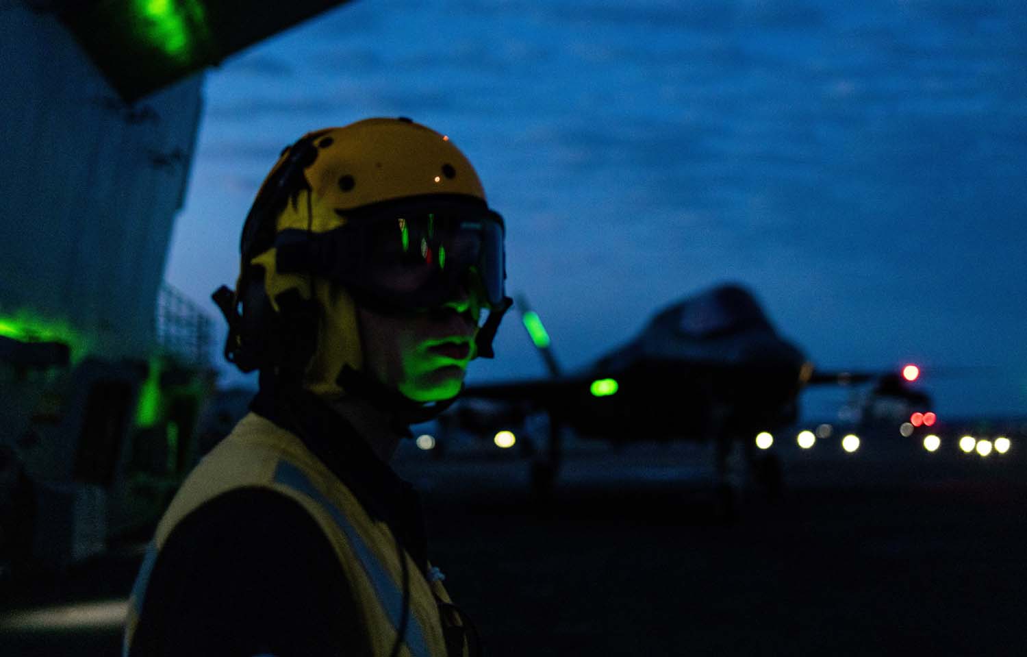 Aircrew on Prince of Wales flight deck with F-35 in background