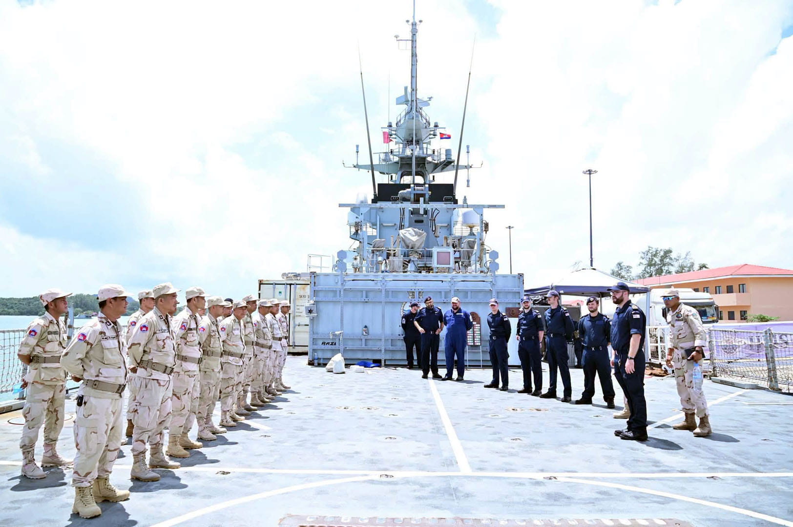 Cambodian military personnel line up on HMS Tamar's flight deck