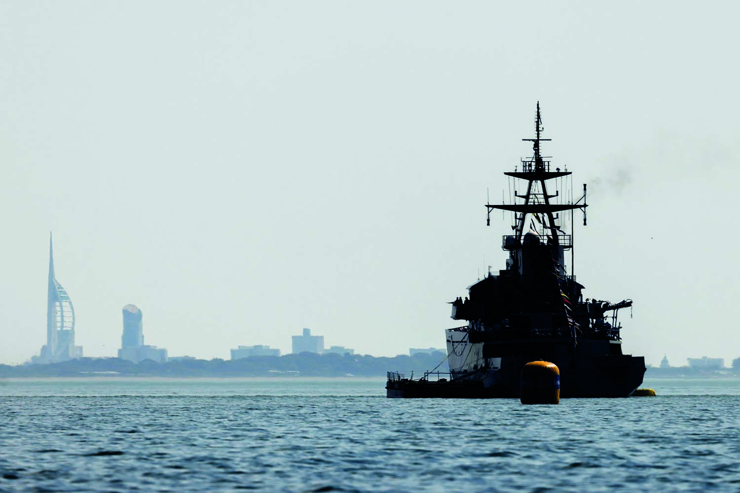HMS Tyne in the Solent with the unmistakable silhouette of Portsmouth in the haze