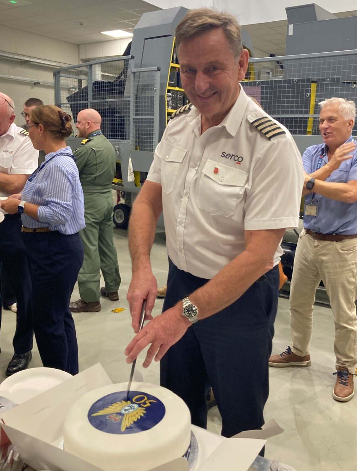 Steve Murray cuts his farewell cake after 50 years in the Fleet Air Arm