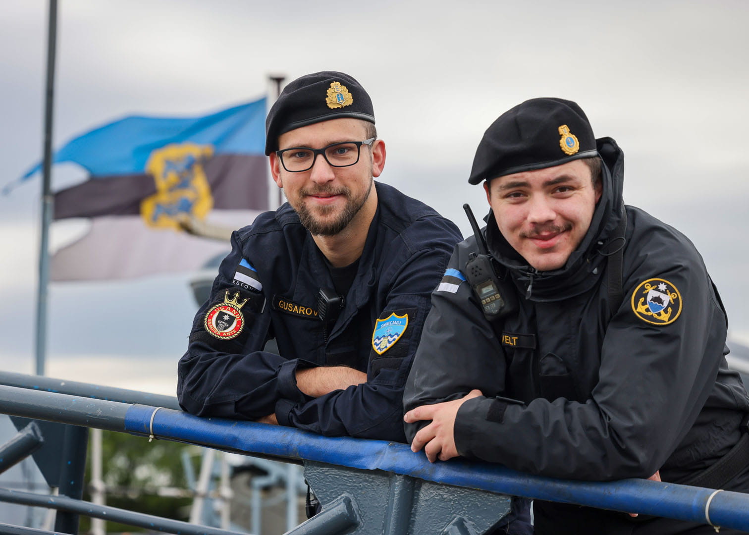 Estonian sailors rest on the gangway of the Ugandi