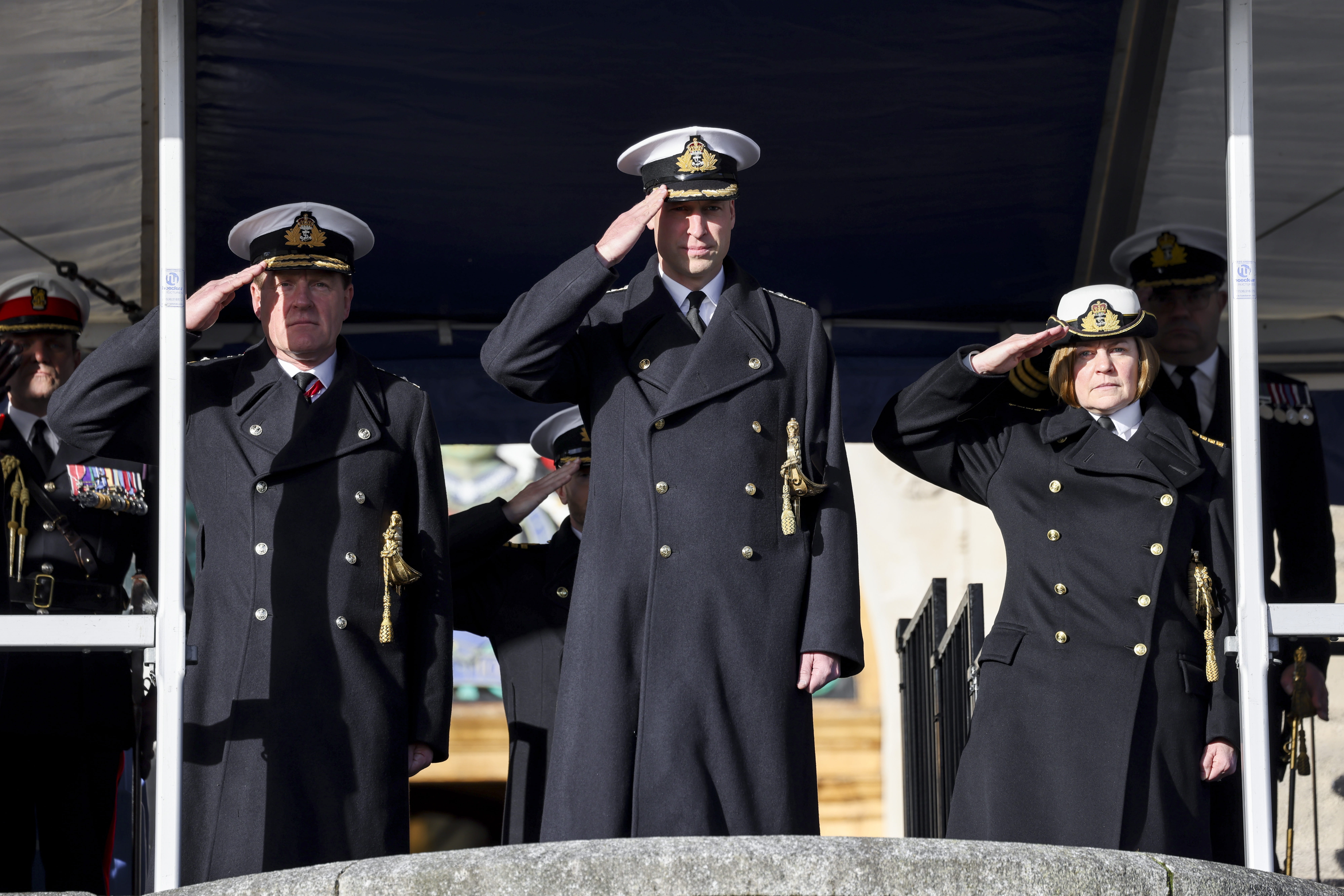 HRH The Prince of Wales (centre), First Sea Lord Admiral Sir Ben Key (left) and Captain Britannia Royal Naval College Captain Sarah Oakley (right) salute the cadets as they pass out HRH The Prince of Wales (centre), First Sea Lord Admiral Sir Ben Key (left) and Captain Britannia Royal Naval College Captain Sarah Oakley (right) salute the cadets as they pass out