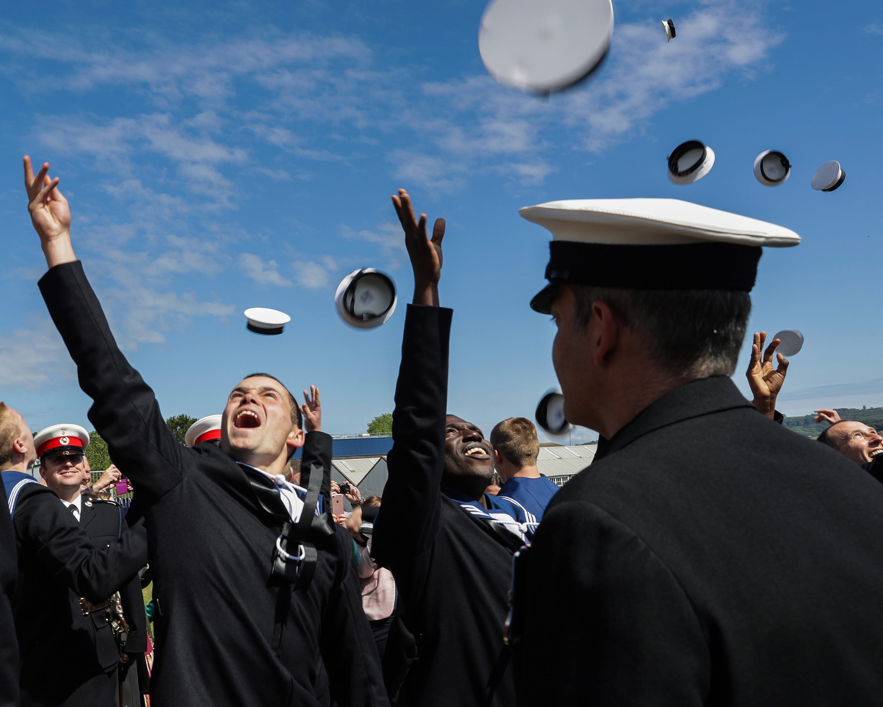 Sailors throw their caps in the air having completed basic training at HMS Raleigh Sailors throw their caps in the air having completed basic training at HMS Raleigh