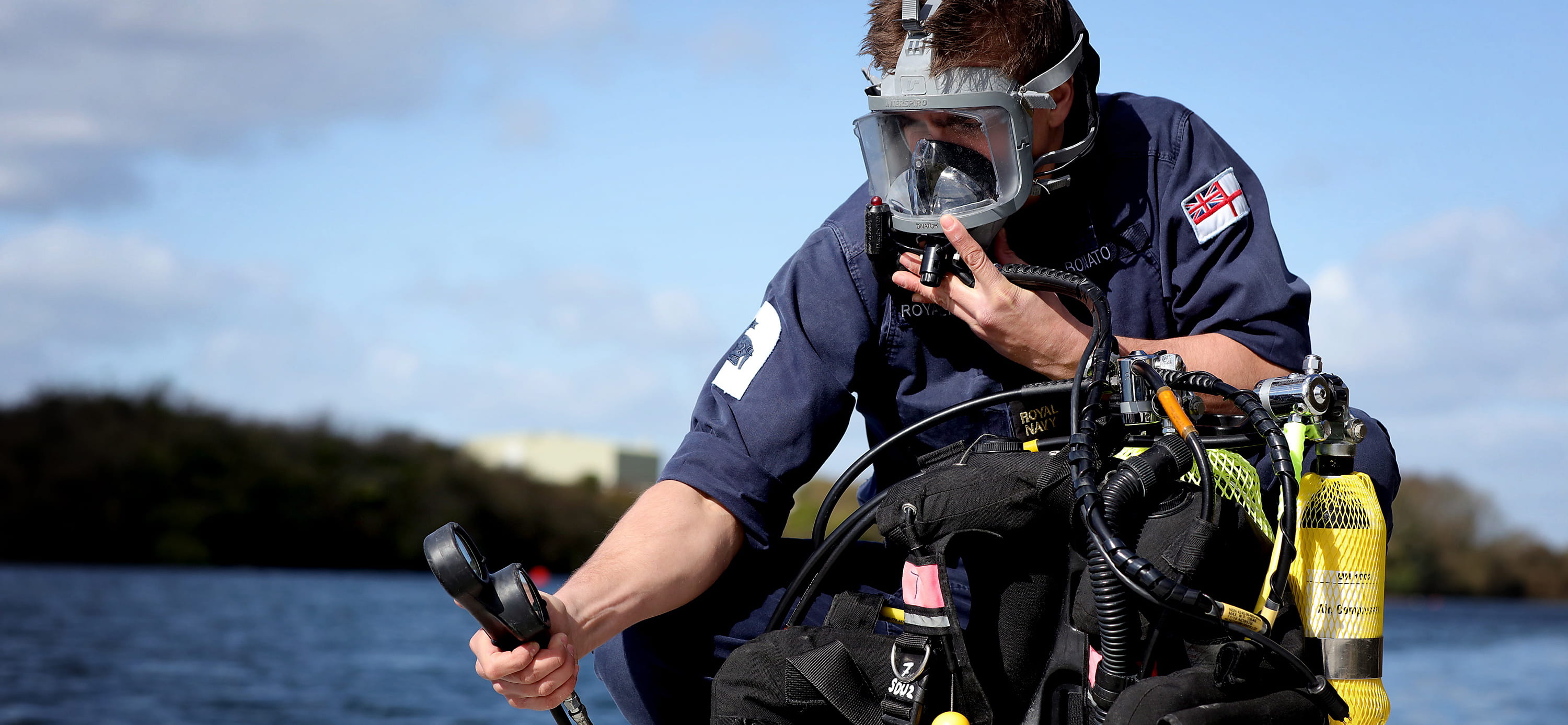 Diver conducting pre diving checks on his dive rig before boarding the RIB.