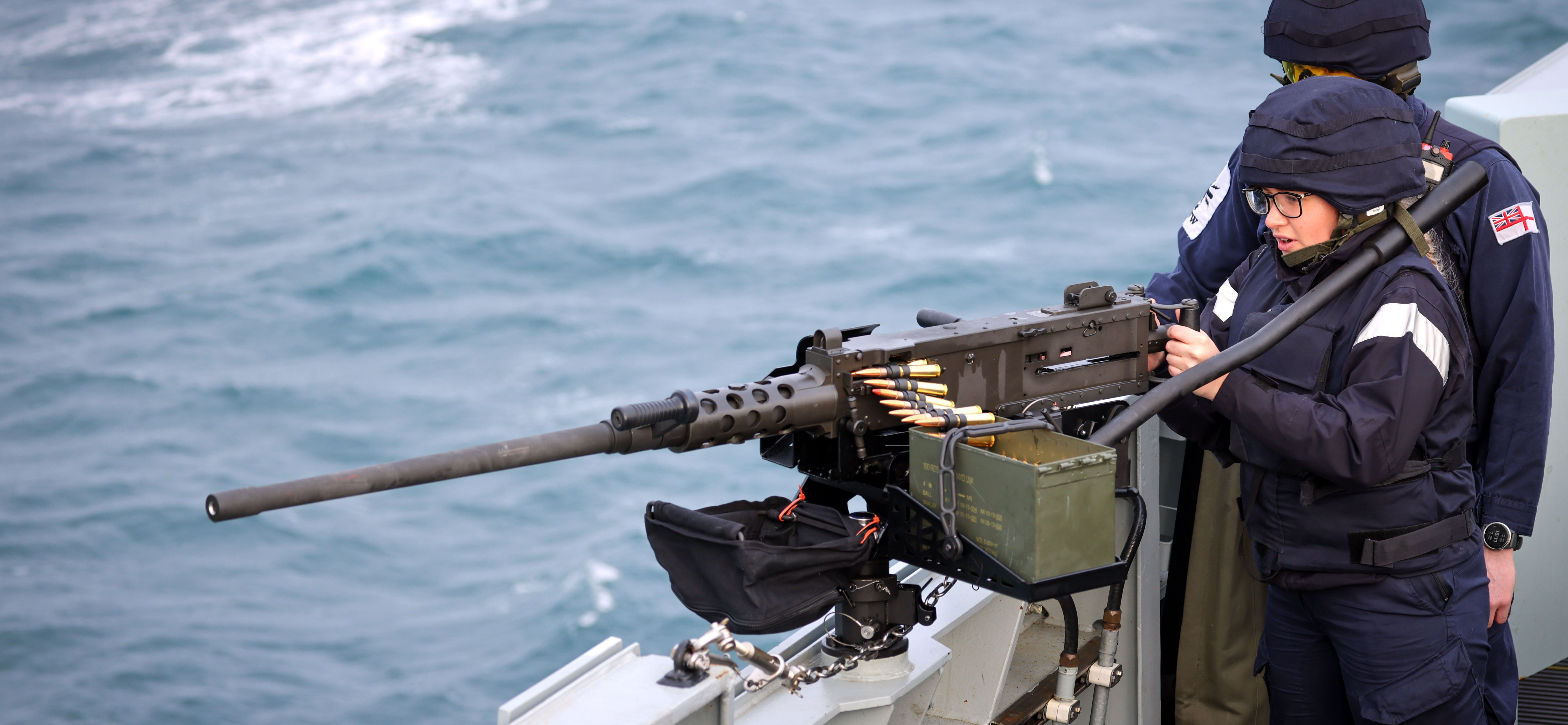 Members of the Above Water Weapons (AWW) Department shooting one of the ships 50 Calibre Heavy Machine Guns (HMG) at a towed target.