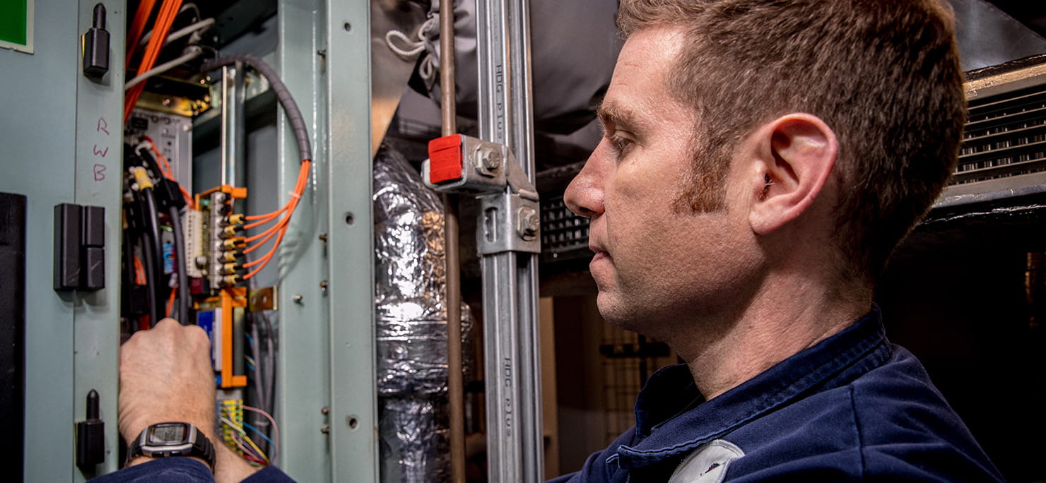 Members of HMS Queen Elizabeth’s Marine Engineering Department fix a defect on one of her propulsion drives.